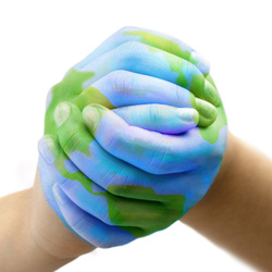 Picture of clasped hands with globe painted on them