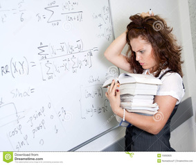 Picture of student at white board looking confused